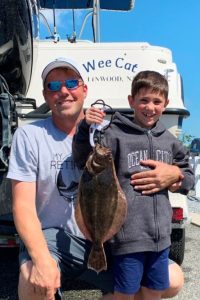 Child with dad holding a flounder in OCNJ