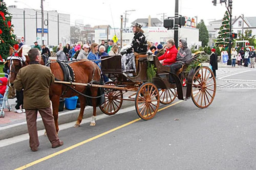 People riding on a horse drawn carriage